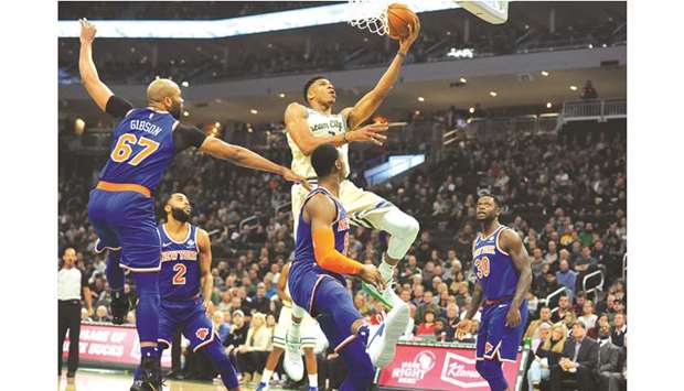 Milwaukee Bucks forward Giannis Antetokounmpo (34) lays up a shot against New York Knicks forward RJ Barrett (9) and forward Julius Randle (30) in the first quarter at Fiserv Forum. PICTURE: USA TODAY Sports