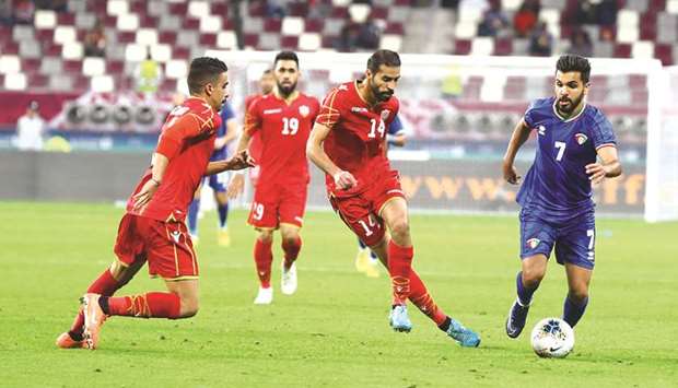 Bahrainu2019s Ali Haram (centre) in action during the 24th Arabian Gulf Cup match against Kuwait on Tuesday. PICTURES: Jayan Orma
