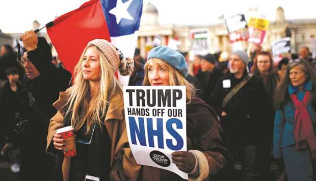 Protesters hold a placard at a demonstration during US President Donald Trumpu2019s visit for the Nato summit, in London yesterday.