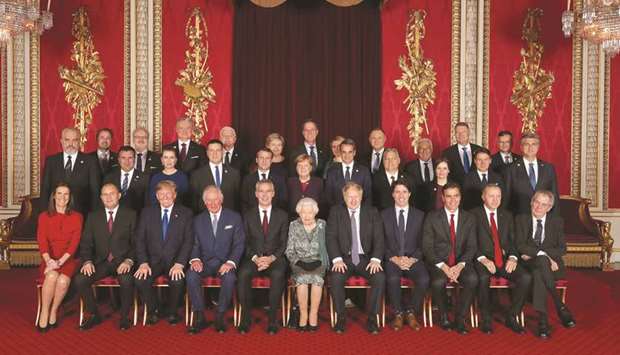 Leaders of Nato alliance countries, and its secretary-general, join Queen Elizabeth II and the Prince of Wales for a group picture to mark 70 years of the alliance.
