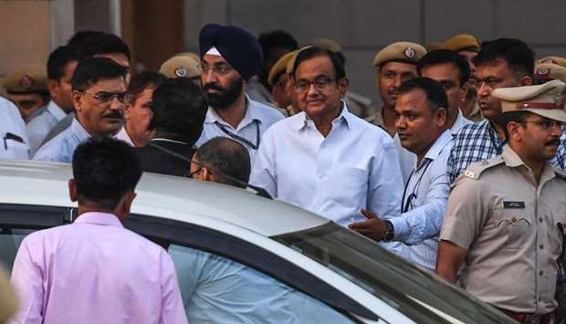 India's former finance minister Palaniappan Chidambaram (C in white shirt with glasses) leaves a court in New Delhi  on August 23.