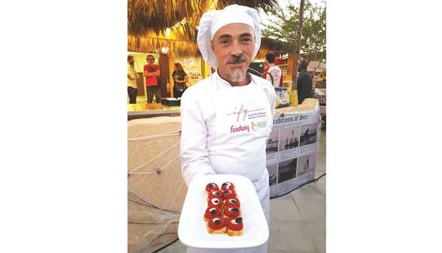 An Italian chef offers festival-goers with authentic Italian cuisine at the opening of Casa Italia, which is taking part at the Katara Traditional Dhow Festival 2019. PICTURE: Joey Aguilar