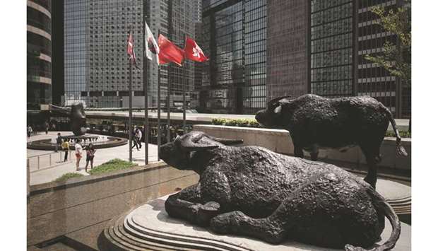 Bull statues displayed outside the Hong Kong Stock Exchange. The Hang Seng index closed down 1.3% to 26,062.56 points yesterday.