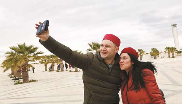 British tourists takes a selfie after arriving to Tunisia with the Thomas Cook travel agency at the Enfidha Airport in Enfidha, Tunisia on February 14, 2018. Visitor  numbers only returned to their earlier levels this year but the collapse of Thomas Cook in September showed how vulnerable Tunisia remains to any sudden shock in the sector.