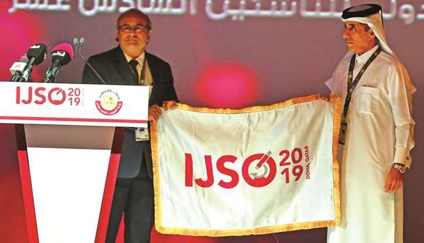 Dr Paresh Joshi handing over the Olympiad flag to Dr Ibrahim bin Saleh al-Naimi.
