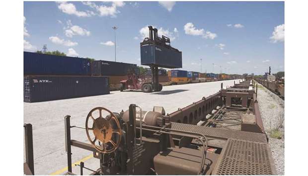 A top loader moves a shipping container to be placed onto a rail car at the Port of Savannah in Savannah, Georgia, US. The Commerce Department said the trade deficit tumbled 7.6% to $47.2bn, the smallest since May 2018, as both imports and exports of goods declined.