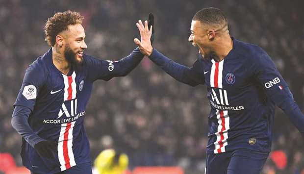 Paris Saint-Germainu2019s Neymar (left) is congratulated by teammate Kylian Mbappe after scoring a goal during the Ligue 1 match against FC Nantes at the Parc des Princes in Paris, France, on Wednesday. (AFP)