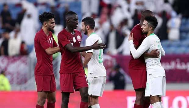 Qatar's players shake hands and embrace with Saudi's after the 24th Arabian Gulf Cup semi-final football match between Saudi Arabia and Qatar at al-Janoub Stadium in the Qatari capital Doha