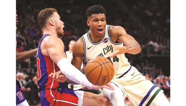Giannis Antetokounmpo (right) of the Milwaukee Bucks drives to the basket against Blake Griffin  of the Detroit Pistons during the second half at Little Caesars Arena on Wednesday. (AFP)