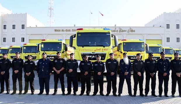 Civil Defence officials with newly-launched firefighting vehicles.rnrn