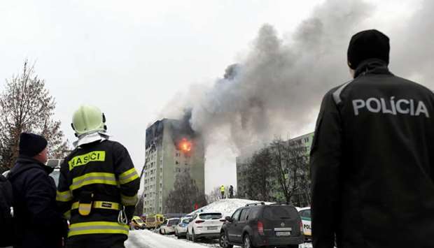 Smoke and fire emanate from an apartment building damaged by a gas explosion in Presov, Slovakia