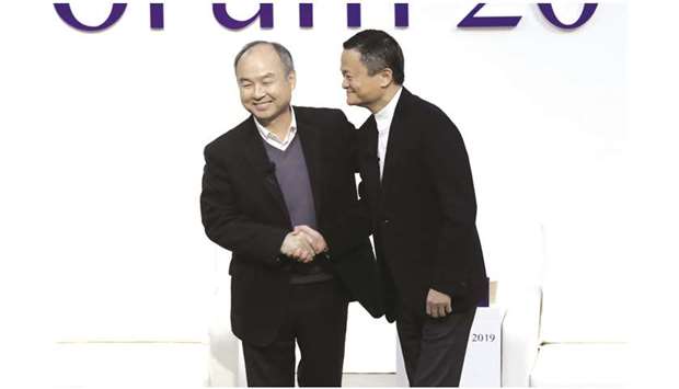 Masayoshi Son (left), and Jack Ma at Tokyo Forum yesterday. Son and Ma exchanged compliments and advocated passion, optimism and world-changing visions as  essential to successful entrepreneurship.