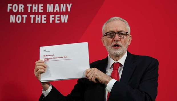 Labour Party leader Jeremy Corbyn shows a document during a news conference in London yesterday.