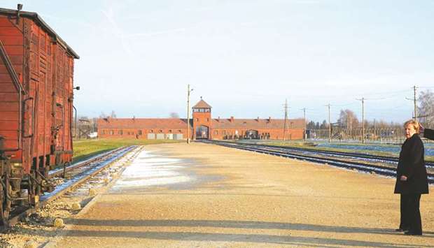 Merkel walks in front of the main railway entrance to Birkenau during her visit to the former German Nazi death camp Auschwitz-Birkenau, in Oswiecim, Poland.