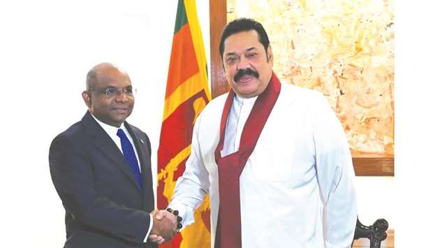Sri Lankau2019s Prime Minister Mahinda Rajapaksa, right, shakes hands with Maldivesu2019 Foreign Minister Abdulla Shahid during a meeting in Colombo yesterday.