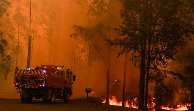 Fire trucks are seen during a bushfire in Werombi, 50 km southwest of Sydney, Australia