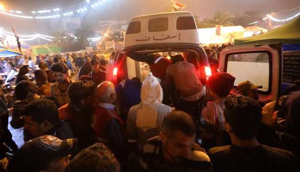 An ambulance arrives in Tahrir square after unidentified men attacked an anti-government protest camp in Baghdad