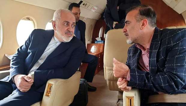 A handout picture released by the Iranian Foreign Minister's official Twitter account shows Foreign Minister Mohammad Javad Zarif (L) and Iranian scientist Massoud Soleimani speaking to each other while sitting in a plane at an undisclosed location.