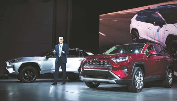 Jack Hollis, group vice president and general manager of Toyota Motor Sales USA Inc, speaks while standing next to the RAV4 XSE hybrid (left) during the 2018 New York International Auto Show. Toyota plans to shift production of the RAV4 hybrid from Canada to a plant in Kentucky  early next year, and also add a plug-in hybrid option from next summer to be imported from Japan.