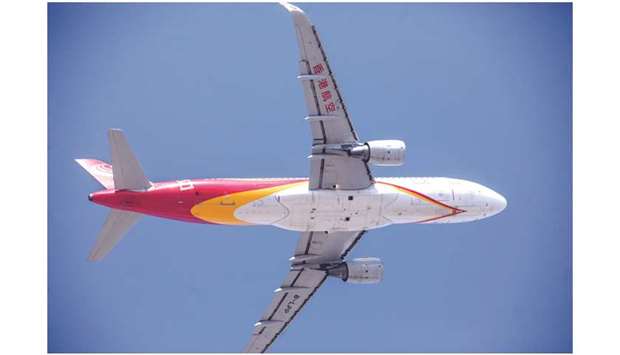 An Airbus A320 aircraft operated by Hong Kong Airlines flies over the Hong Kong International Airport. The low-cost carrier was allowed to continue flying after the cityu2019s authorities decided yesterday not to punish it for delaying salary payments and ongoing financial problems.