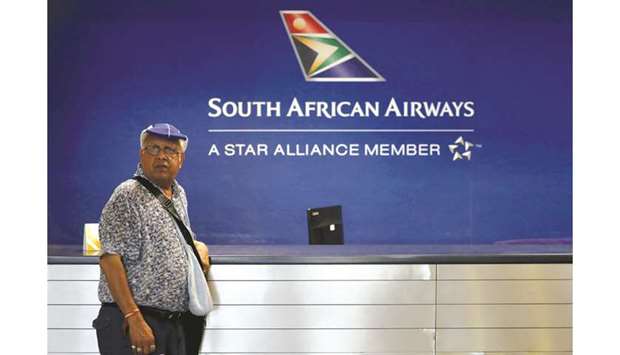 A passenger waits to be served at the South African Airways customer desk at the O. R. Tambo International Airport in Kempton Park, South Africa (file). The scaling back of SAAu2019s global network has been a fixture of previous restructuring plans drawn up to ease debt and stem persistent losses, which amount to more than 28bn rand over 13 years.