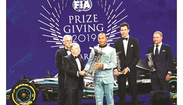 FIA president Jean Todt presents Lewis Hamilton (centre) the Formula 1 driversu2019 championship trophy during the FIAu2019s prize-giving gala in Paris, France, on Friday. (Twitter/FIA)