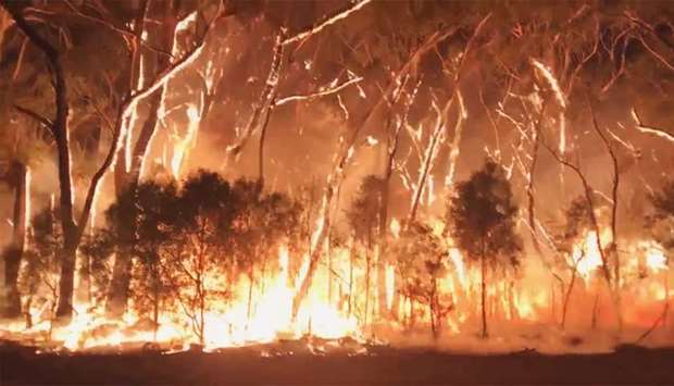 A fire blazes across bush in Newnes Plateau, New South Walles, Australia