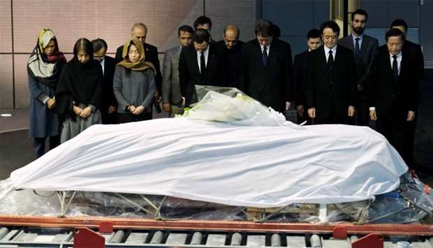 Government officials and relatives of late Japanese physician Tetsu Nakamura offer silent prayers in front of Nakamura's coffin