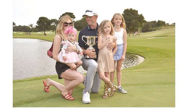 Australian golfer Matt Jones (centre) holds the trophy surrounded by his family after winning the Australian Open at the Australian Golf Club in Sydney yesterday. (AFP)