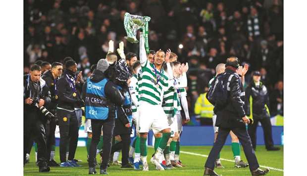 Celticu2019s Christopher Jullien (centre) celebrates winning the Scottish League Cup final with teammates after the win over Rangers in Glasgow, Scotland, yesterday. (Reuters)