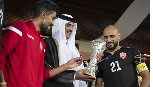 His Highness the Amir Sheikh Tamim bin Hamad al-Thani presenting the 24th Arabian Gulf Cup trophy to the members of the national football team of Bahrain.