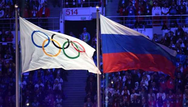 The Olympic flag (L) and the Russian flag