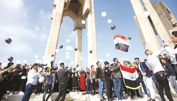 University of Basra students carry balloons as they take part in an anti-government protest, yesterday.