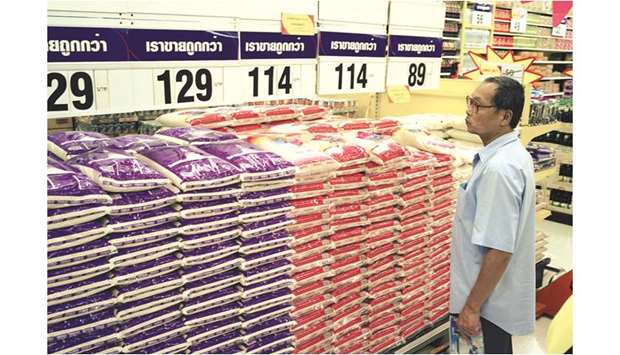 A shopper inspects the price of rice at a Tesco store in Bangkok. Tesco is considering the sale of its operations in Thailand and Malaysia as it refocuses on the domestic business amid mounting challenges in the UK.