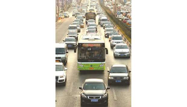 Buses creep slowly through heavy traffic in downtown Beijing. Sales of sedans, sport utility vehicles, minivans and multipurpose vehicles fell 4.2% from a year earlier to 1.97mn units, the China Passenger Car Association said yesterday.
