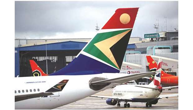 The logo of South African Airways is seen on an aircraft at O.R. Tambo International Airport in Johannesburg (file). SAA has posted losses since 2012 as it grappled with the high operating costs of an ageing, inefficient jet fleet and a bloated workforce, on top of high taxes, political interference and corruption scandals.