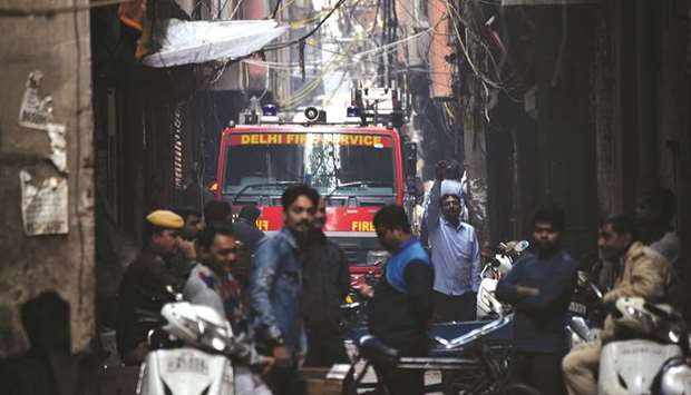 A Delhi Fire Service truck is seen along a street near the site where a fire broke out in Anaj Mandi area of New Delhi yesterday.