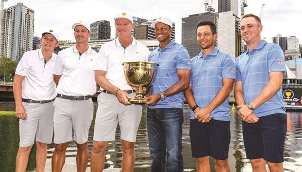 (From left) International team players Cameron Smith, Adam Scott, captain Ernie Els, US team captain Tiger Woods, and players Xander Schauffele and Justin Thomas pose with the Presidents Cup trophy in Melbourne, Australia, yesterday. (AFP)