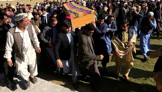 Afghan men carry the coffin of journalist Malalai Maiwand, who was shot and killed by unknown gunmen in Jalalabad, Afghanistan