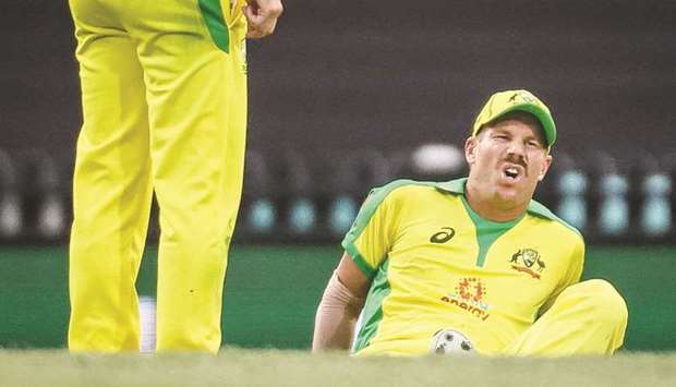 Australiau2019s David Warner reacts after he suffered an injury during the ODI match against India at the Sydney Cricket Ground (SCG) in Sydney on November 29.