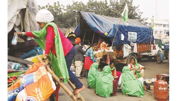 Women prepare food at the site of a protest against newly passed farm bills at Tikri border near Delhi yesterday.