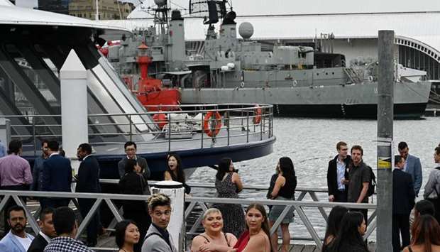 People wait to board a cruise boat at the city centre's waterfront following further easing of coronavirus disease (Covid-19) restrictions in Sydney, Australia