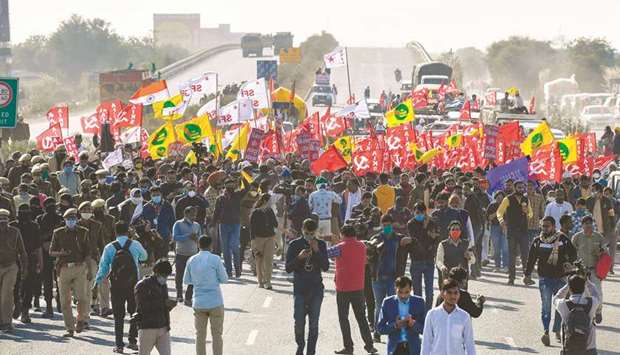 Farmers and union leaders march along a highway on the Haryana-Rajasthan border to protest against the central governmentu2019s recent agricultural reforms, in Rewari district yesterday.