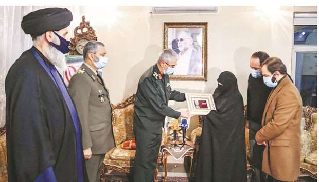 A handout picture provided by the office of Iranu2019s Supreme Leader Ayatollah Ali Khamenei yesterday shows Iranian Armed Forces Chief of Staff Major General Mohamed Bagheri decorating the wife (centre-right) of assassinated nuclear scientist Mohsen Fakhrizadeh (pictured) with a badge of merit during a ceremony held in the capital Tehran.