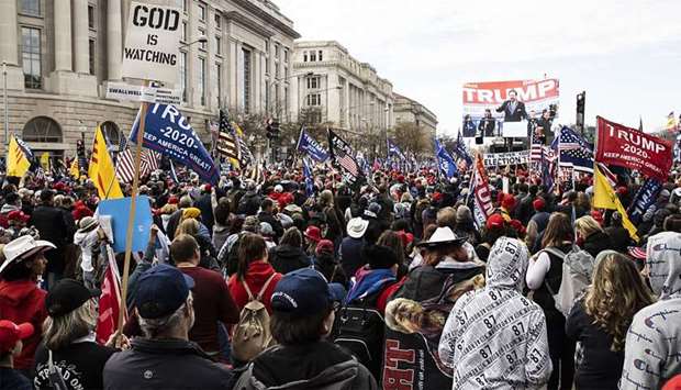 People gather in support of President Donald Trump and in protest the outcome of the 2020 presidential election near freedom plaza in Washington