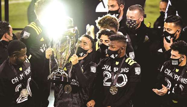 Lucas Zelarayan (second from left) of Columbus Crew lifts the trophy after a 3-0 win over the Seattle Sounders in the MLS Cup Final in Columbus, Ohio, United States, on Saturday. (AFP)