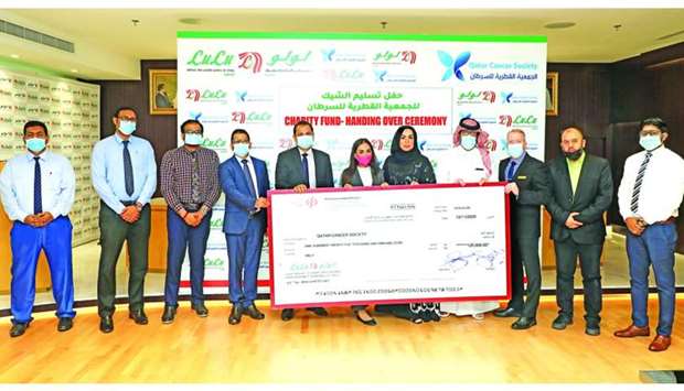 QCS and LuLu Hypermarket Qatar officials at the cheque handover ceremony.