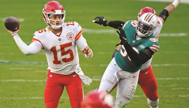 Kansas City Chiefs quarterback Patrick Mahomes (left) attempts a pass against the Miami Dolphins during the first half at Hard Rock Stadium in Miami Gardens, Florida, United States, on Sunday. (USA TODAY Sports)