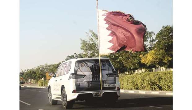 A vehicle decorated with the Qatar National Flag and images of His Highness the Amir Sheikh Tamim bin Hamad al-Thani and His Highness the Father Amir Sheikh Hamad bin Khalifa al-Thani on a Doha road yesterday. PICTURE: Shaji Kayamkulam.