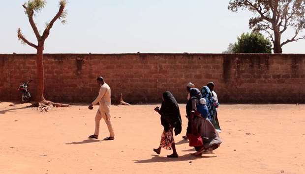 Parents of abducted students walk inside the Government Science school in Kankara, in northwestern Katsina state, Nigeria
